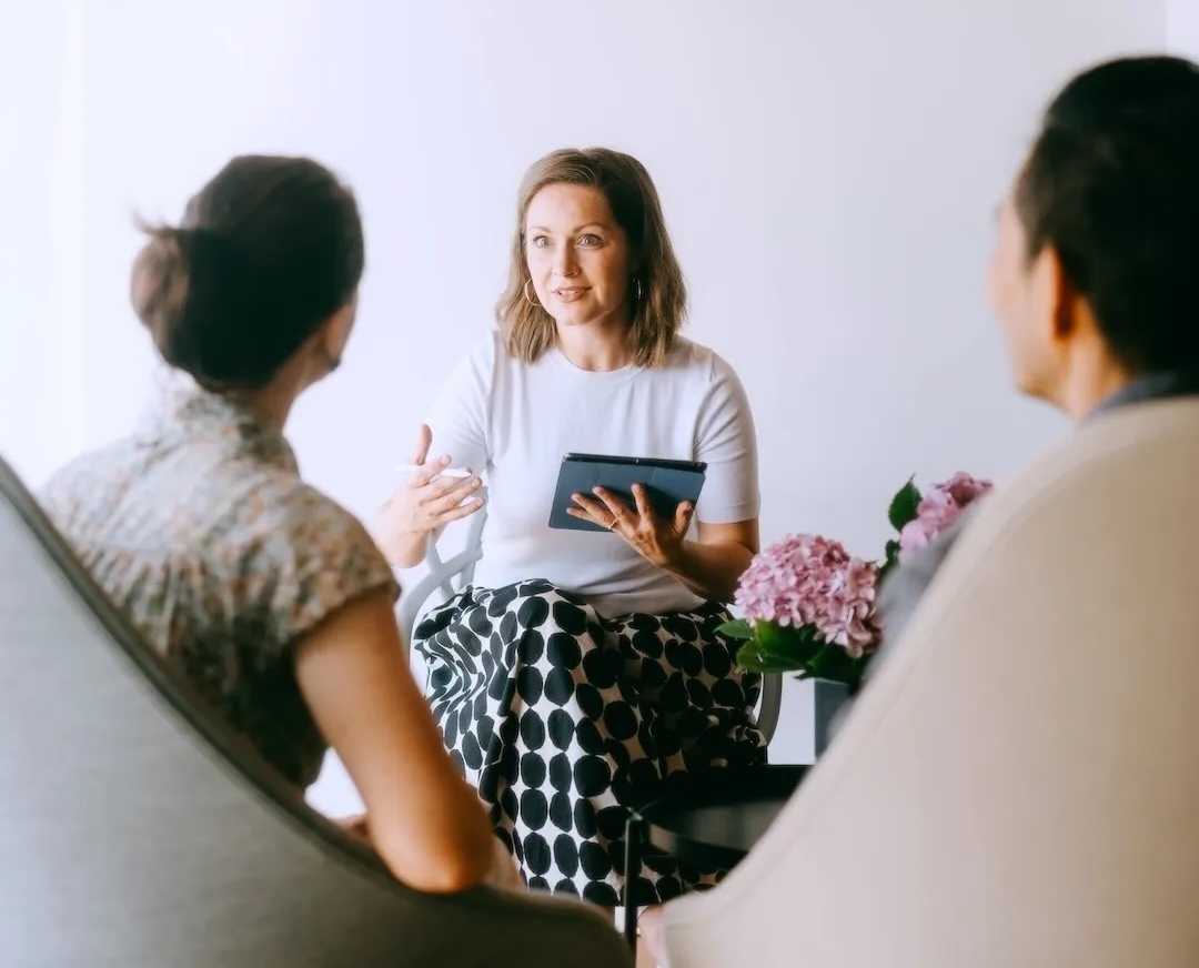 3 people sitting together talking
