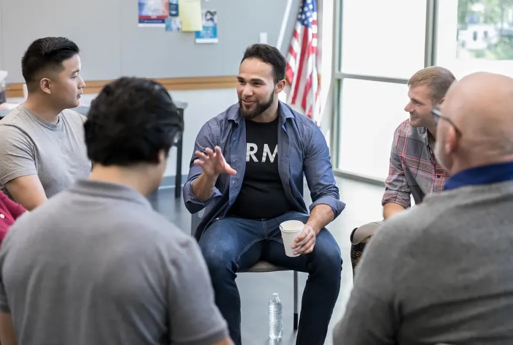 A group of people siting in a circle talking