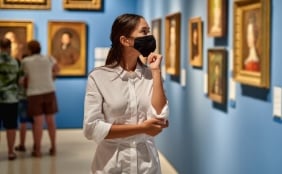 person wearing a face mask in a art museum