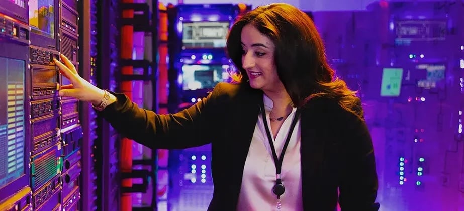 Person in server room with purple hue