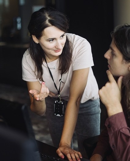 two people talking at table in office