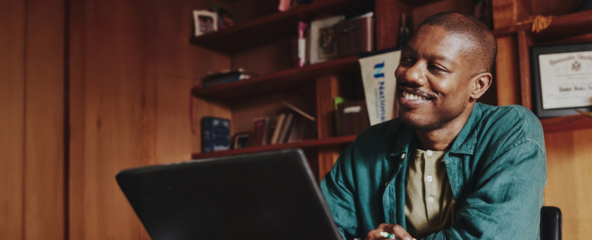 person on laptop at office desk