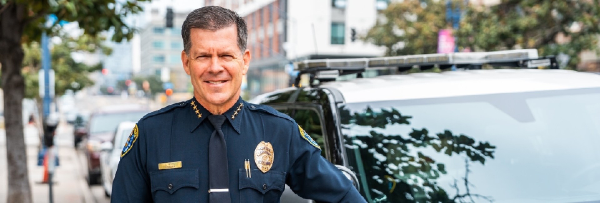 Police officer standing next to the police car